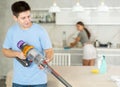 Positive guy and wife are cleaning kitchen Royalty Free Stock Photo