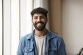 Positive handsome Arab entrepreneur man standing for shooting indoors