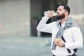 Positive handsome businessman having lunch near office building Royalty Free Stock Photo