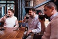 Positive handsome men tasting beer