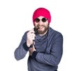 Positive handsome young bearded hipster in pink knitted hat smoking a pipe, expresses various emotions and shows Royalty Free Stock Photo