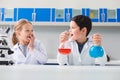 Positive happy boy holding flasks Royalty Free Stock Photo