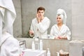 positive happy caucasian couple doing daily morning procedures in bathroom