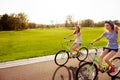 Positive happy girls in love ride bicycles and have fun Royalty Free Stock Photo