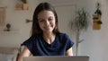 Positive happy young freelancer woman using laptop at home Royalty Free Stock Photo