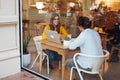 Positive hipster girl enjoying friendly communication with colleague