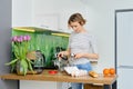 Positive housewife making coffee in coffee machine