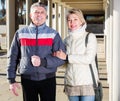 Positive husband and wife are walking together