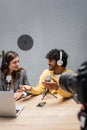 positive indian podcaster in headphones and Royalty Free Stock Photo