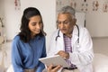 Positive Indian practitioner doctor showing medical test results to patient Royalty Free Stock Photo