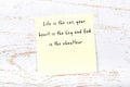 Positive inspiring quote handwritten on sticky note on wooden background Royalty Free Stock Photo