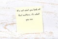 Positive inspiring quote handwritten on sticky note on wooden background Royalty Free Stock Photo