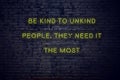 Positive inspiring quote on neon sign against brick wall be kind to unkind people they need it the most Royalty Free Stock Photo