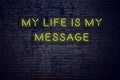 Positive inspiring quote on neon sign against brick wall my life is my message