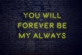 Positive inspiring quote on neon sign against brick wall you will forever be my always