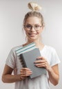 Portrait of young student girl with books isolated over grey wall background Royalty Free Stock Photo