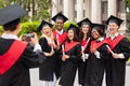 Positive international students celebrating graduation, taking photos Royalty Free Stock Photo