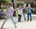 Positive kids playing street football outdoors Royalty Free Stock Photo