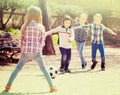Positive kids playing street football outdoors Royalty Free Stock Photo