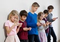 Kids using their mobile phones Royalty Free Stock Photo