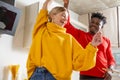 Positive lady smiling while dancing with happy man