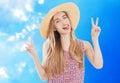 Positive lady in summer hat posing on blue background