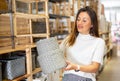 Latino american woman choosing wicker baskets in shop