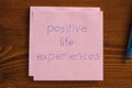 Positive life experiences written on a note
