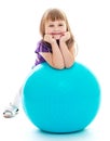 Positive little girl with the blue ball. Royalty Free Stock Photo