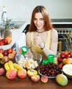 Positive long-haired woman cooking fruit salad