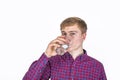 Positive looking teenager is drinking water out of a  glass Royalty Free Stock Photo