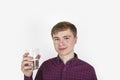 Positive looking teenager is drinking water out of a  glass Royalty Free Stock Photo