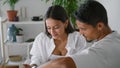 Positive lovers laughing home closeup. Married couple reading funny book Royalty Free Stock Photo