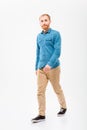 Positive male with beard walking and looking camera Royalty Free Stock Photo