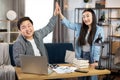 Positive male and female IT specialists giving high five Royalty Free Stock Photo