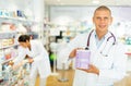 Male pharmacist offers various body care medicines