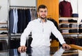 Positive male seller in men`s boutique