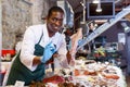 Salesman offering fresh calamari