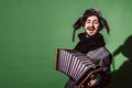 A very positive man with an accordion posing in the studio Royalty Free Stock Photo