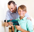 Father and son repairing house Royalty Free Stock Photo