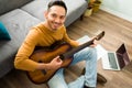 Positive man with good mental health holding a guitar