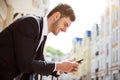 Positive man holding cell phone Royalty Free Stock Photo