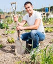 Man professional horticulturist with garden shovel at land