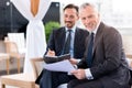 Positive man sitting with his colleague