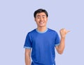 Positive man thumb pointing finger away paying your attention at empty space for advertisement, Royalty Free Stock Photo