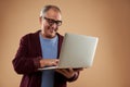 Positive man using modern laptop and looking happy Royalty Free Stock Photo