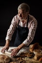 Experienced Baker Man preparing dough for homemade bread in the kitchen. Royalty Free Stock Photo