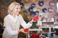 Positive mature female purchasing ceramic cookware Royalty Free Stock Photo