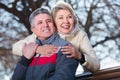 positive mature married couple sitting on park bench Royalty Free Stock Photo