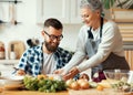 Happy mother serving healthy food to adult son at home